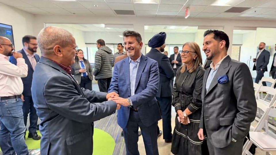 Business leaders greeting one another at an Entry Open event