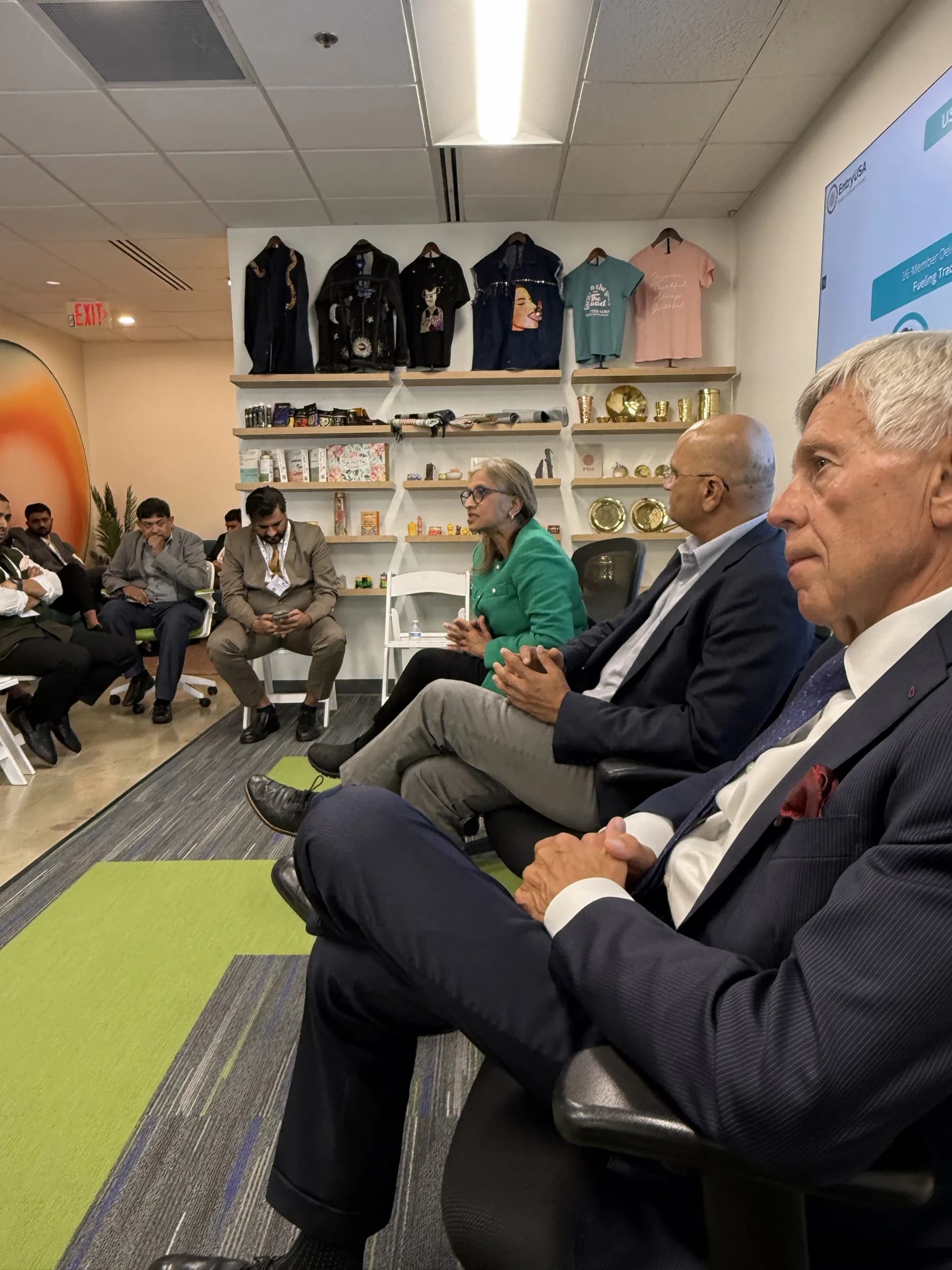Business leaders in conversation during a gathering inside USICC