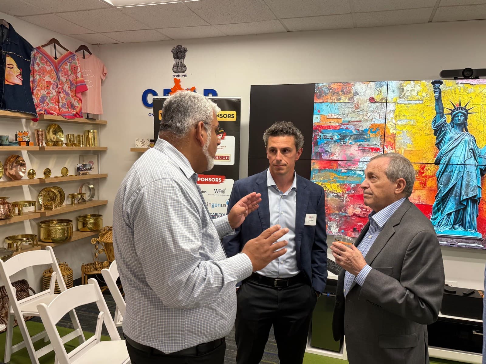 Business visitors discussing products beside the USICC showcase