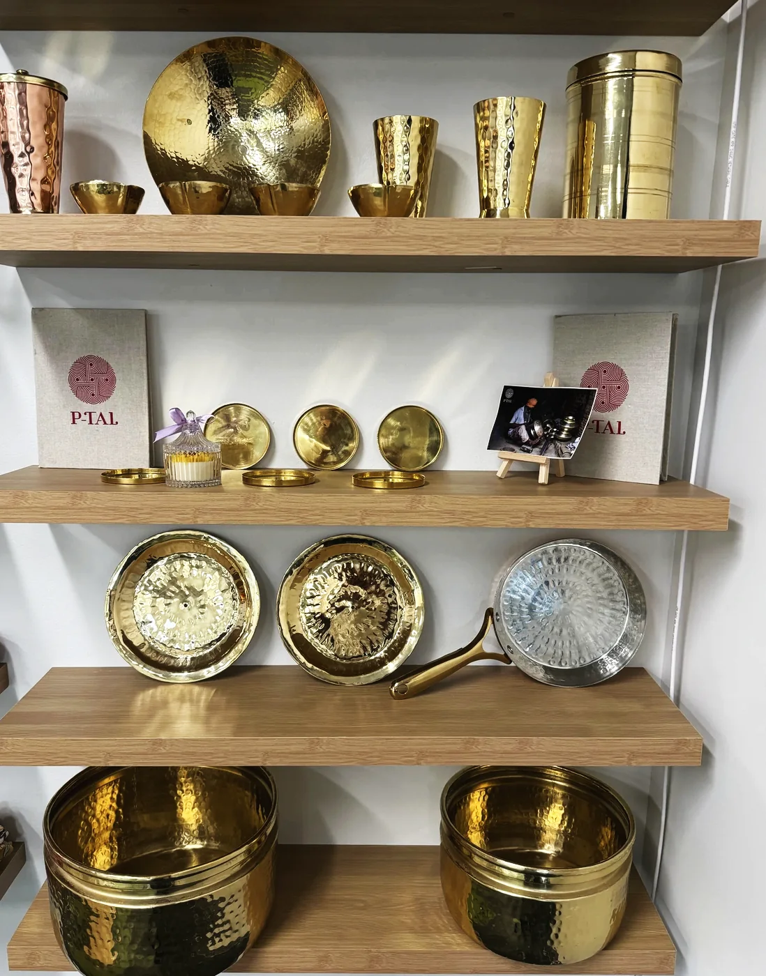 Brass vessels and bowls on open shelves