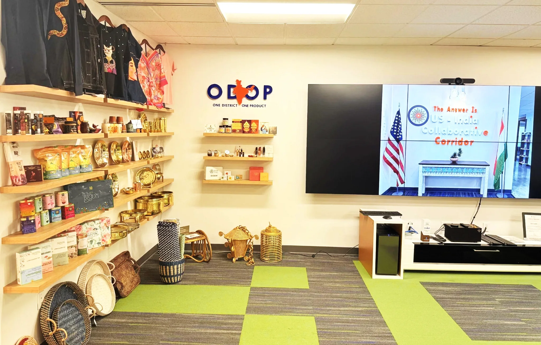 The showcase wall: garments above, packaged goods and brass below